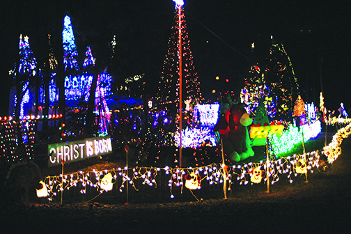 File photo. Visitors to the Christmas Village of Lights travel a path outlined in candy canes to visit Santa and the miniature indoor village display. Also, visitors can take part in a scavenger hunt through the village sets. 