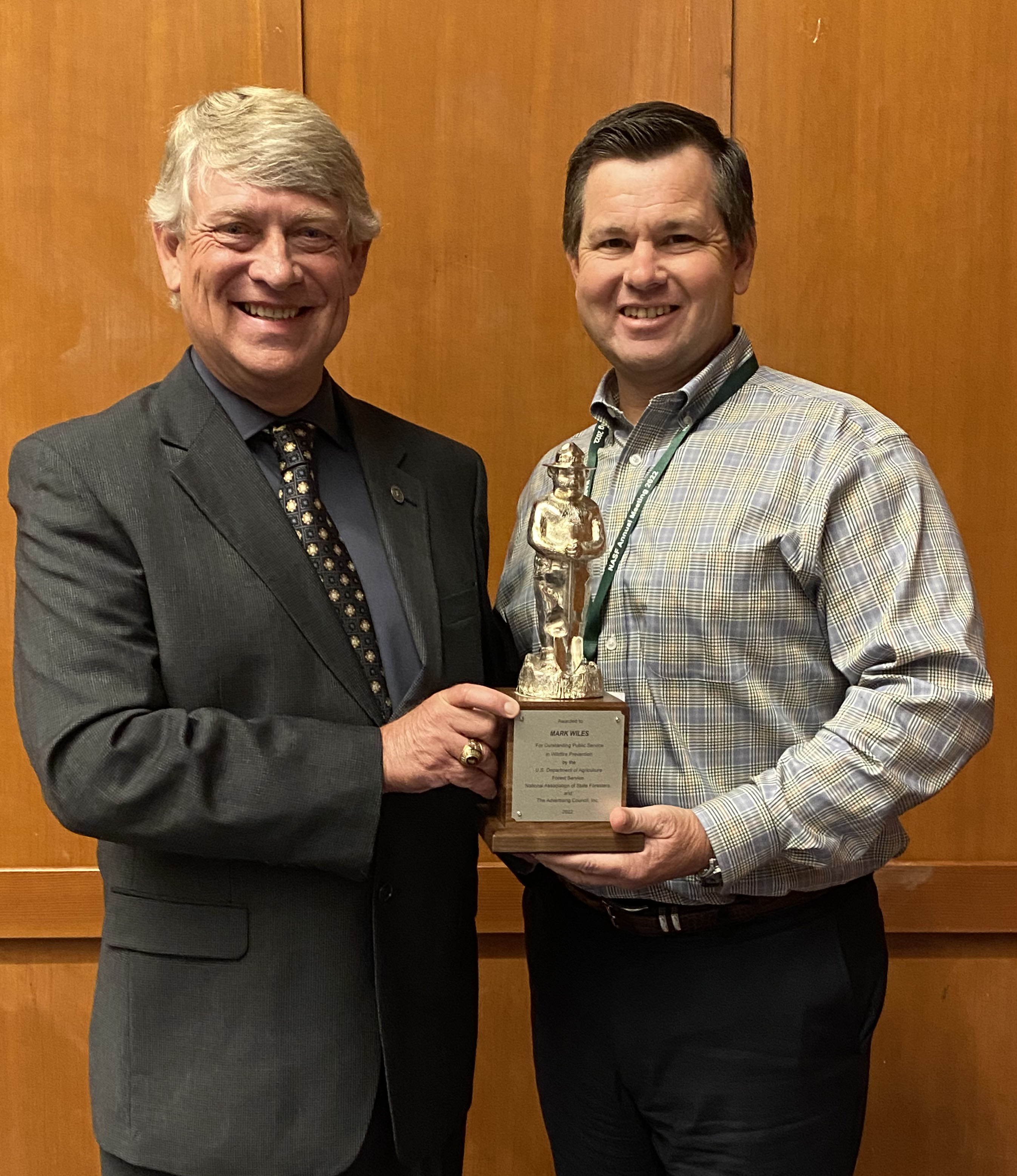 Submitted photo. Georgia Forestry Commission (GFC) Wildfire Mitigation Specialist Mark Wiles, left, is congratulated by GFC Director Tim Lowrimore, right, for earning the 2022 Silver Smokey Bear Award. The honor is given biannually by the National Association of State Foresters, the U.S. Forest Service, and the Ad Council to those whose regional work provides outstanding service and impact in the prevention of wildfires.
