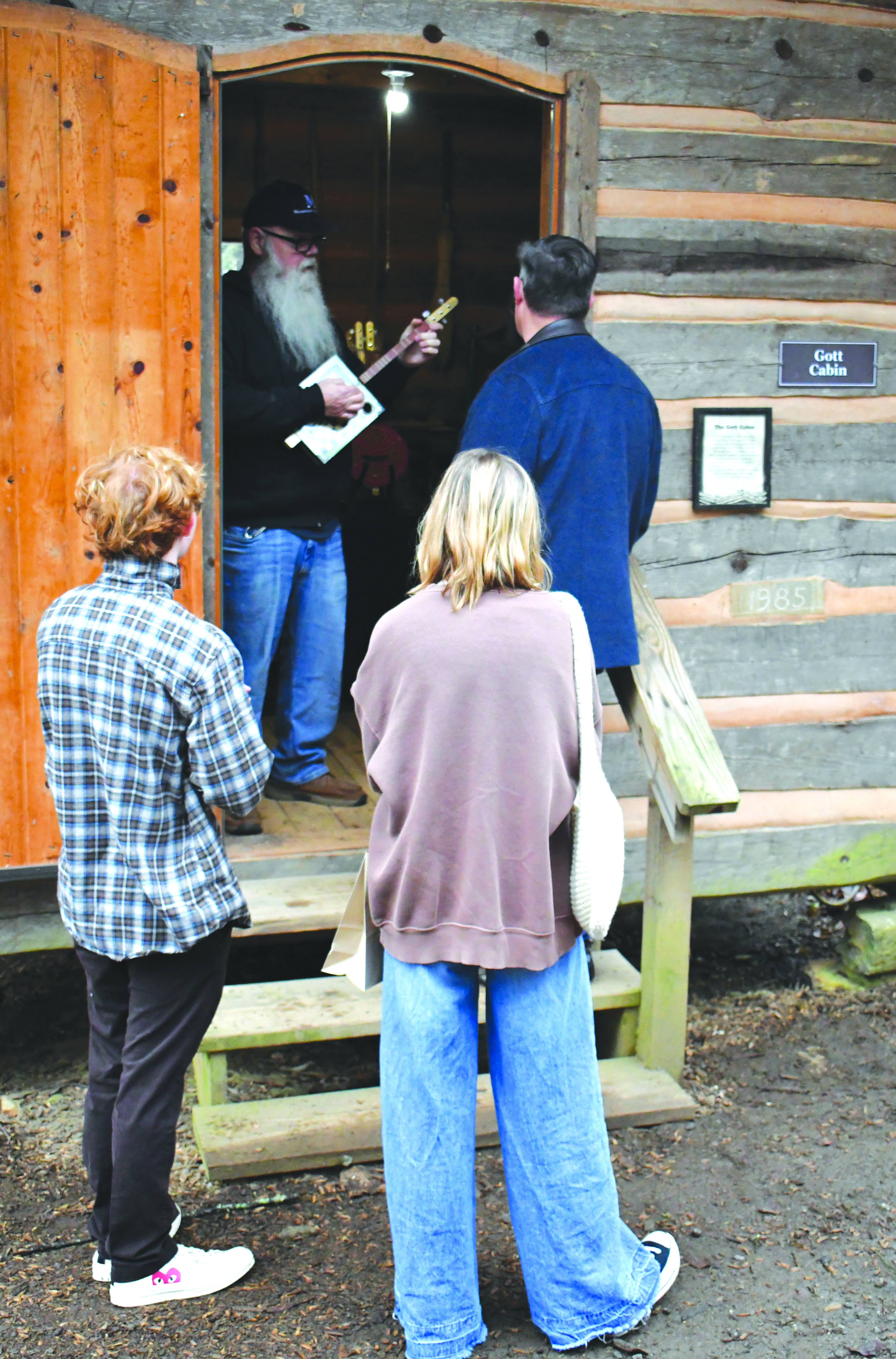 Enoch Autry/The Clayton Tribune. Les Barnett plays one of his handmade musical instruments.