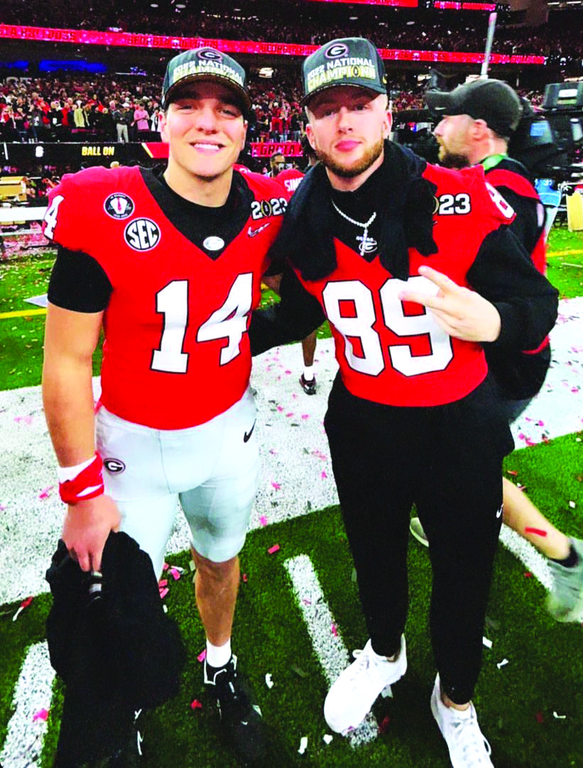 Submitted photo. Rabun County standouts Gunner Stockton and Braxton Hicks sport their new national champion caps after the Bulldogs’ Monday win.