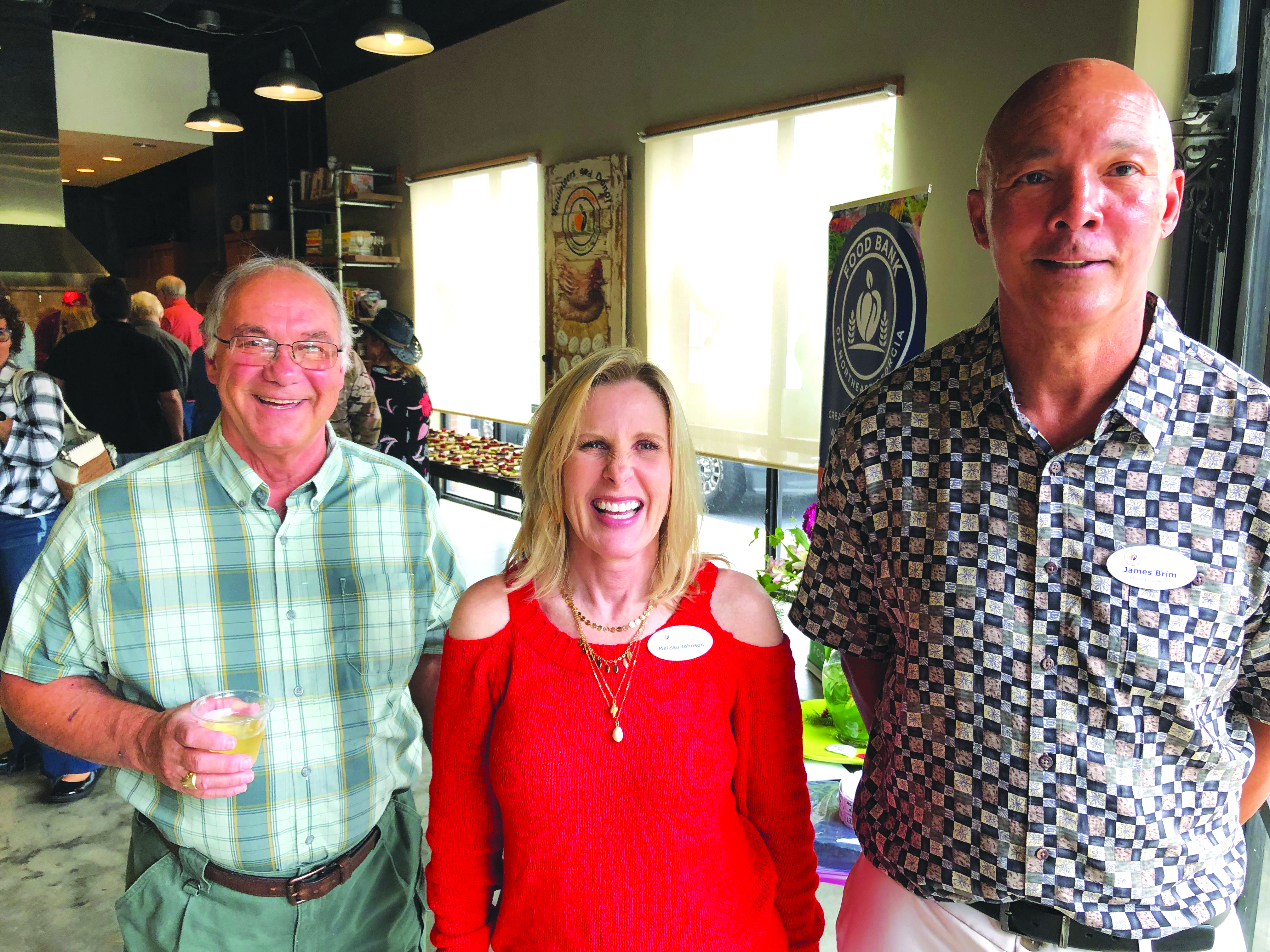 Submitted photo. Chester Baumgartner; Melissa Johnson, Food Bank outreach manager; and James Brim, Food Bank Mountain director, take part at event.