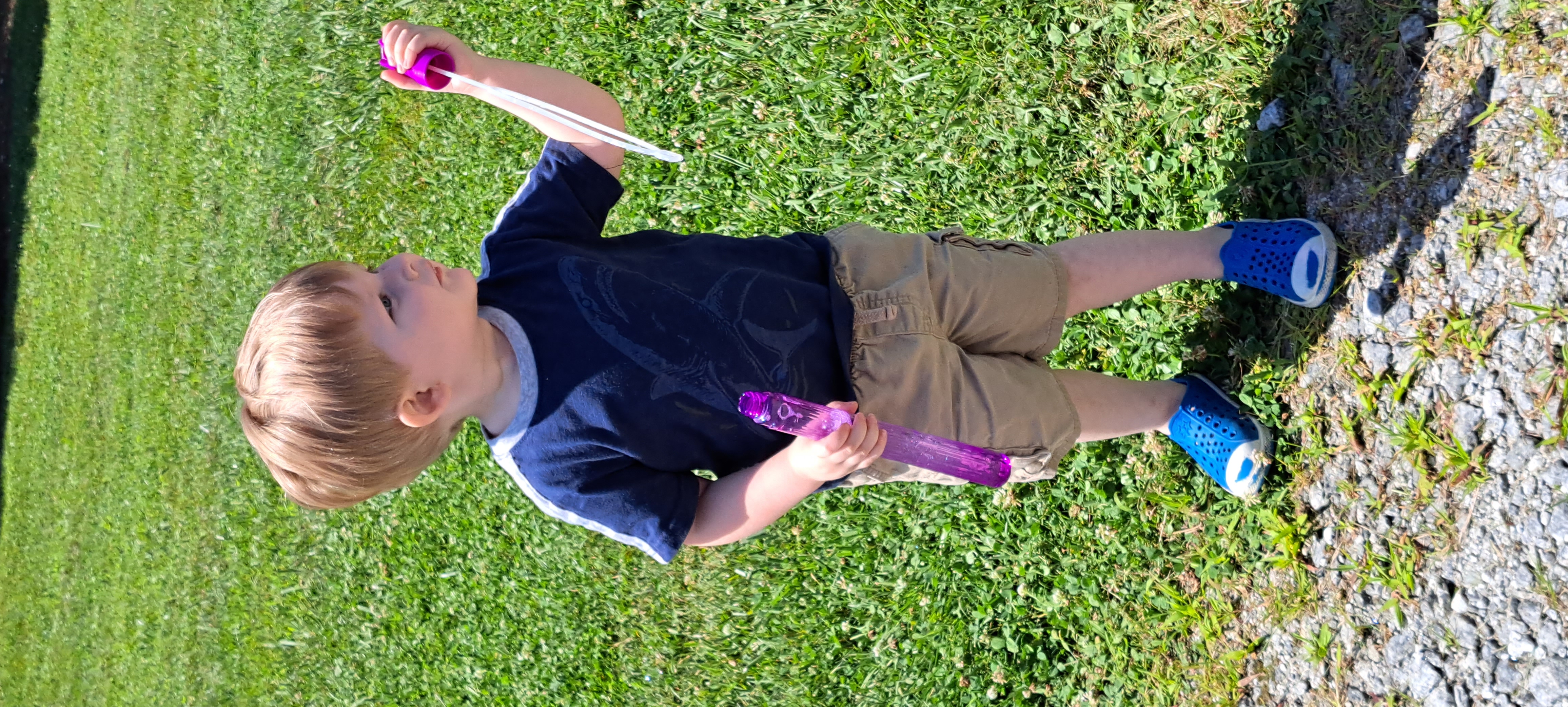 Megan Broome/The Clayton Tribune. Rohan Burt, 3, enjoys blowing bubbles during the Happy Helpings launch, Georgia’s Food Service Program for Kids, at the pavilions behind Rabun County Public Library June 13.