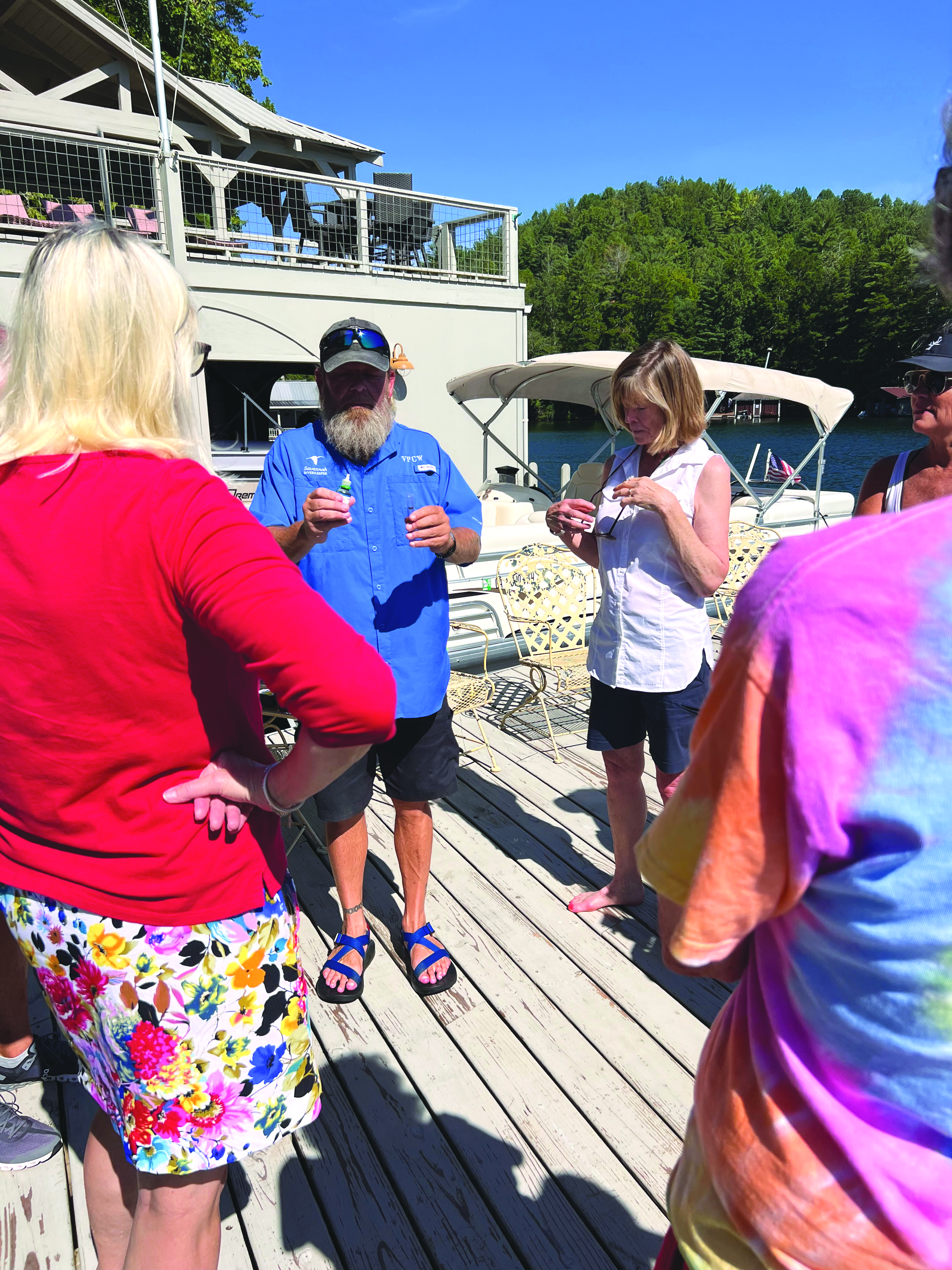 Submitted photo. A member of Veterans for Clean Water shows volunteers how to sample and test the Lake Burton water.