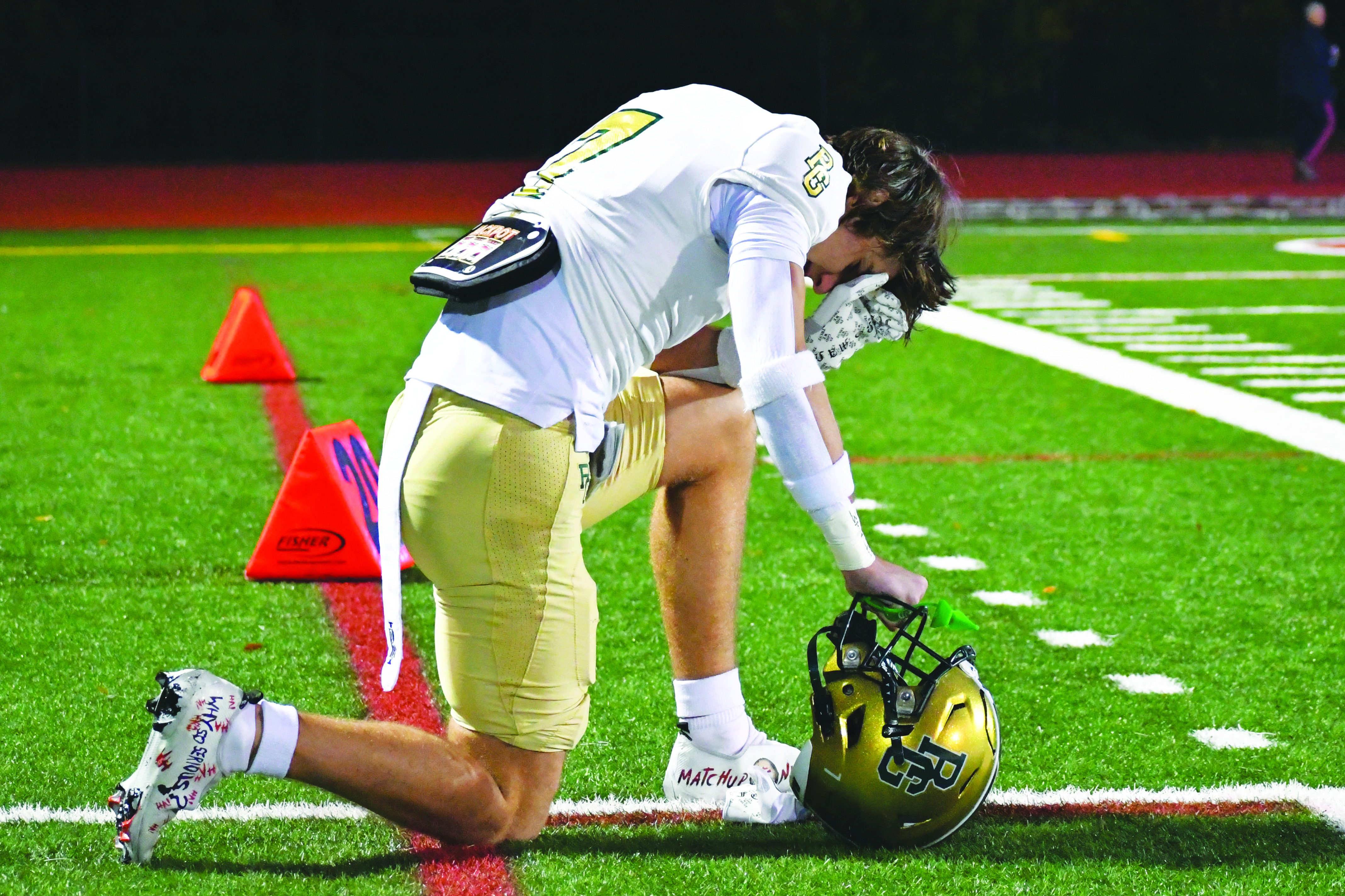 Wade Cheek/The Clayton Tribune. Eagle tight end Marshall Pritchett kneels alone just before RGNS kicked off to the Chargers last Friday.