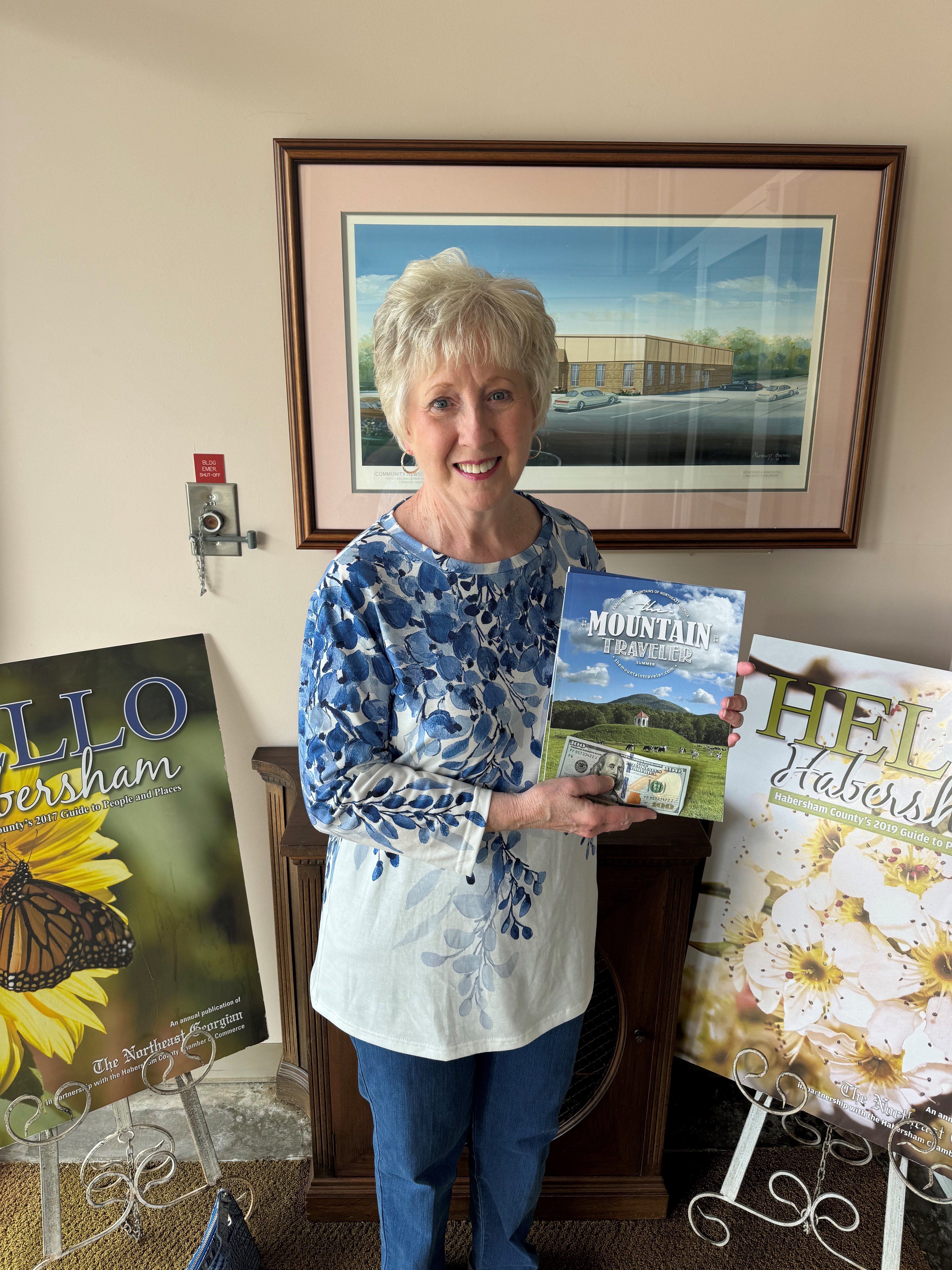 Matthew Osborne/CNI News Service. Donna Shirley poses with a copy of the new Mountain Traveler magazine that is available countywide. Shirley’s photo graces the cover.
