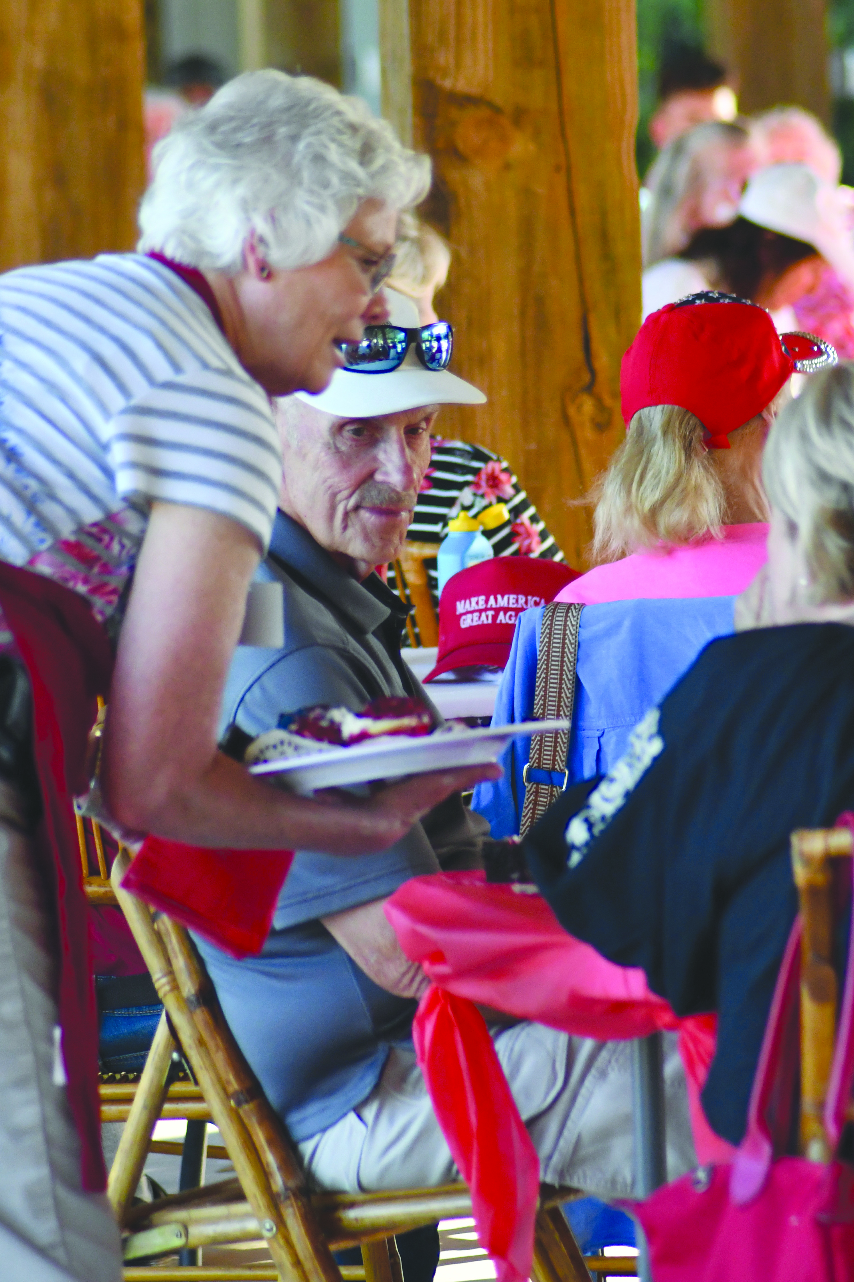 Enoch Autry/The Clayton Tribune. Rabun County Republican Party Treasurer Linda Burns brings brownie desserts around to those at the Aug. 24 low country boil.