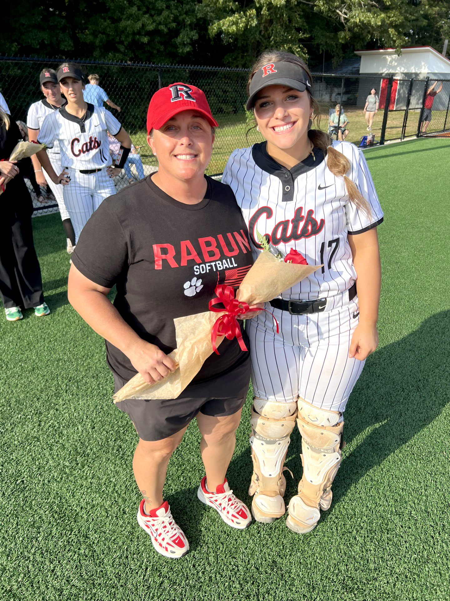 Submitted Photo. Rabun County head softball coach Jessica Evans (left) poses with her daughter and Wildcat catcher sophomore River Evans before a game this season.