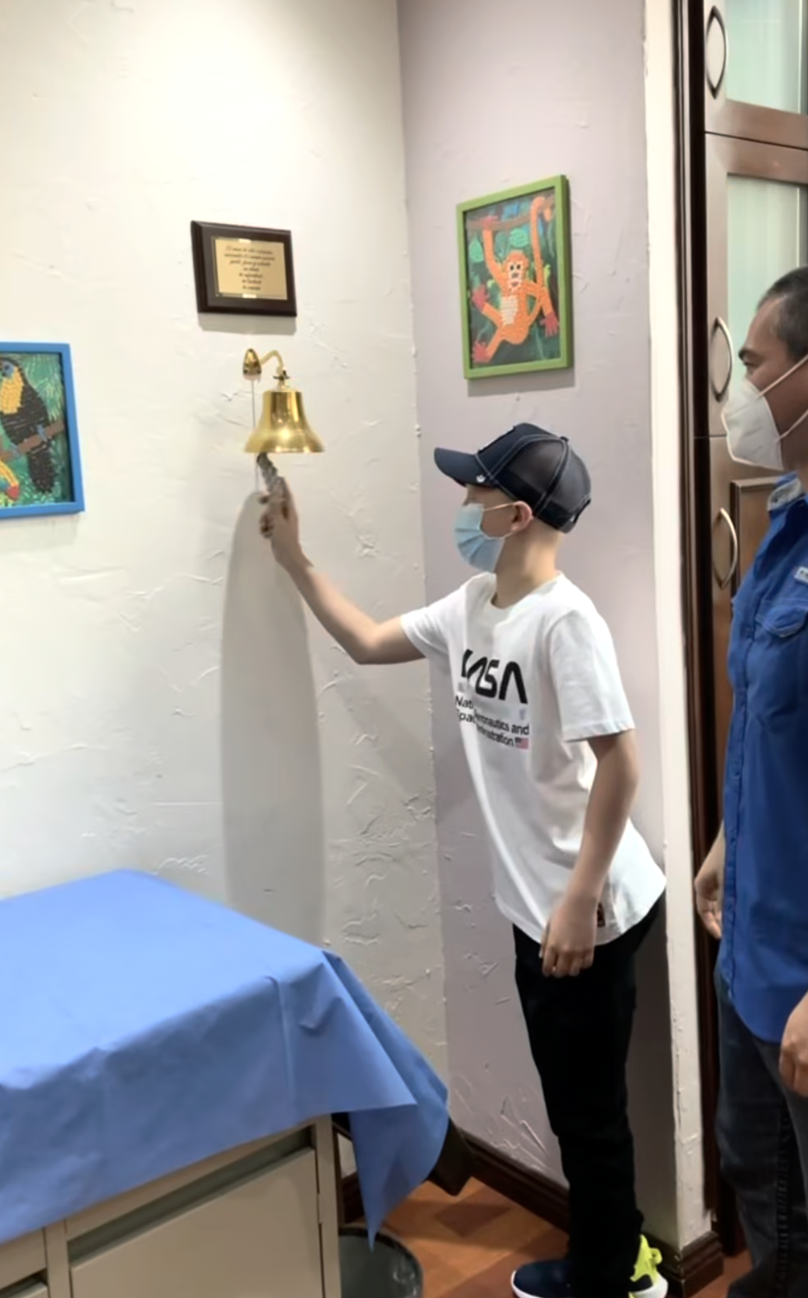 Submitted. Hector Nahle, pictured here at 12 years old, rings the bell after becoming cancer-free. Nahle was diagnosed with bone cancer as a child, but has persevered and continues to pursue his football dream.
