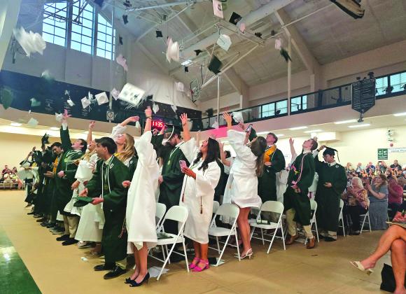 Enoch Autry/The Clayton Tribune.  The graduating class of the Tallulah Falls School toss their caps into the air at the conclusion of the May 22 commencement inside the TFS Lower/Middle School Campus Activity Center. 