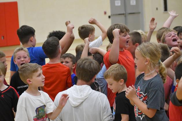 Wesley Branch/The Clayton Tribune.  The younger age group of campers at the Rabun County basketball camp at the Rabun County Recreation Department wrap up day two of camp on June 2. In the middle is RCHS head coach David Adcock.