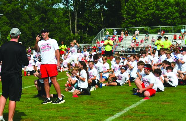 Enoch Autry/The Clayton Tribune. Former Rabun County standout and current University of Georgia quarterback Gunner Stockton takes a selfie with youth participants of the Gunner Stockton Football Camp sitting on the field at Lakeview Academy on June 20 in the background. This is the camp’s second year.