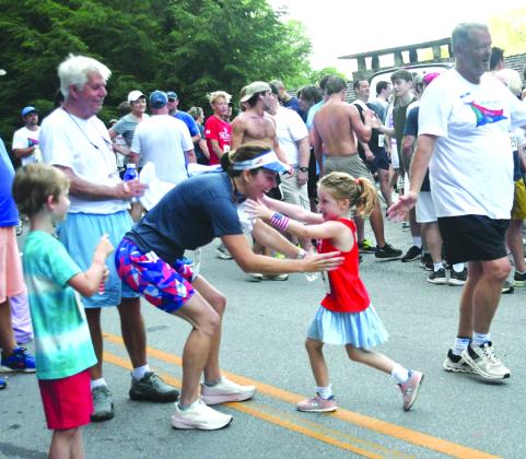 File/Enoch Autry/The Clayton Tribune. At last year’s Rabun Ramble, 5-year-old Carver Harris, runs toward the awaiting arms of her mother Courtney Harris following their 5K runs at the event in Lakemont. This year’s Rabun Ramble will be Saturday, July 4.