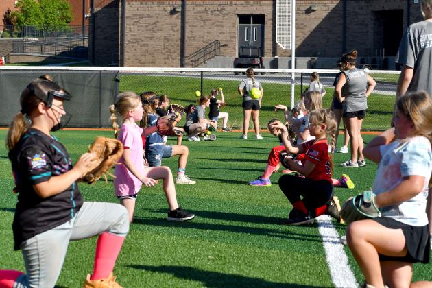 Wesley Branch/The Clayton Tribune. RCHS softball campers throw the ball to each other to warm up during the Rabun County softball camp at Rabun County High School on June 15. The camp was offered to kids aged 5-12 years old