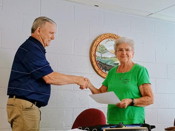 Megan Horn/The Clayton Tribune. Mountain City Mayor Grace Watts, right, shakes hands and congratulates C.L. Faulkenberry as the newest council member on June 9. 