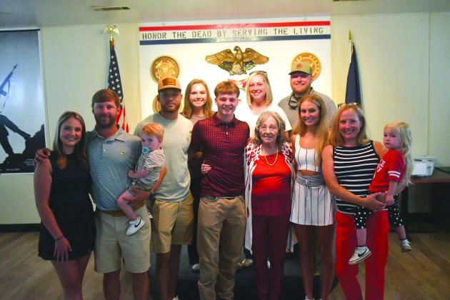 Wesley Branch/The Clayton Tribune. Huey Blalock (center) poses with his family for a photo after being administered his oath of service at VFW Post 4570 in Clayton on June 24. Blalock, who is a midshipman candidate, will head to NAPS, the Naval Academy’s 10-month preparatory school. Blalock was an All-State basketball player for Rabun County.