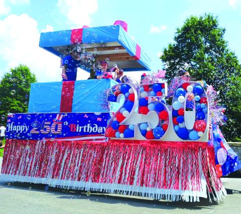 Megan Horn/The Clayton Tribune. This “Present of Freedom” float by O.L.I. Home Solutions was the parade winner in the Sky Valley Independence Day grand parade on Friday, July 3. The day was filled with fun, food and a fireworks show.