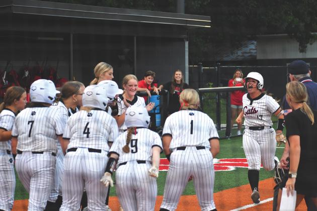 Wesley Branch/The Clayton Tribune. The Rabun County softball team celebrates River Evans’ go-ahead grand slam in the bottom of the sixth inning of the Wildcats’ 15-14 win against East Jackson on Aug. 3. Evans, a junior, went 3-for-4 on the night with a single, double and grand slam.