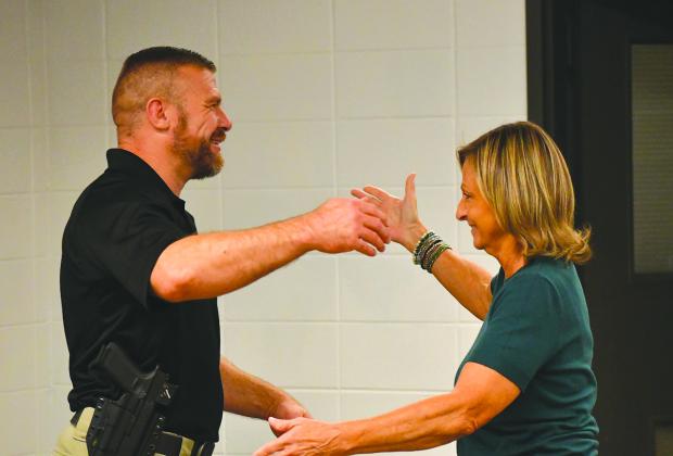 Enoch Autry/The Clayton Tribune. Clayton City Manager Trudy Crunkleton (right) prepares to give Kevin Marsteller a hug after the city council unanimously approved the current major with the Corneila Police Department as Clayton’s new police chief. Marsteller will succeed Michael Turner, who has announced his resignation effective Aug. 28.