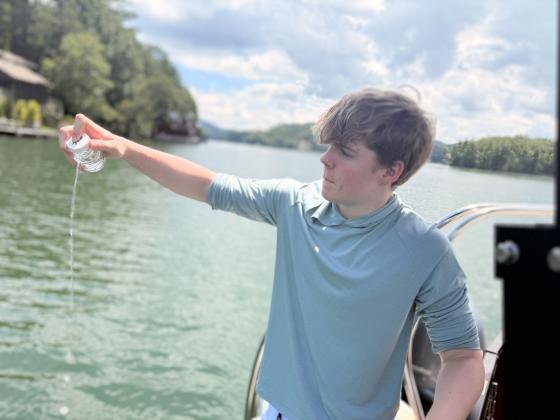 Submitted photo. Henry Dumas collects water from Lake Burton, which he will take back to test for E. Coli levels in the IDEXX laboratory on the TFS campus. 