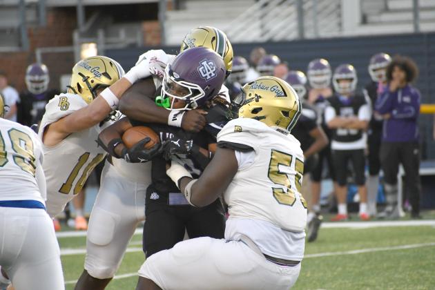 Wesley Branch/The Clayton Tribune. The Rabun Gap defense brings down Ambassador Christian School running back Ezekiel Kelly during its 31-6 win over the Lions on Sept. 25. RGNS’ defense forced three turnovers in the victory. 