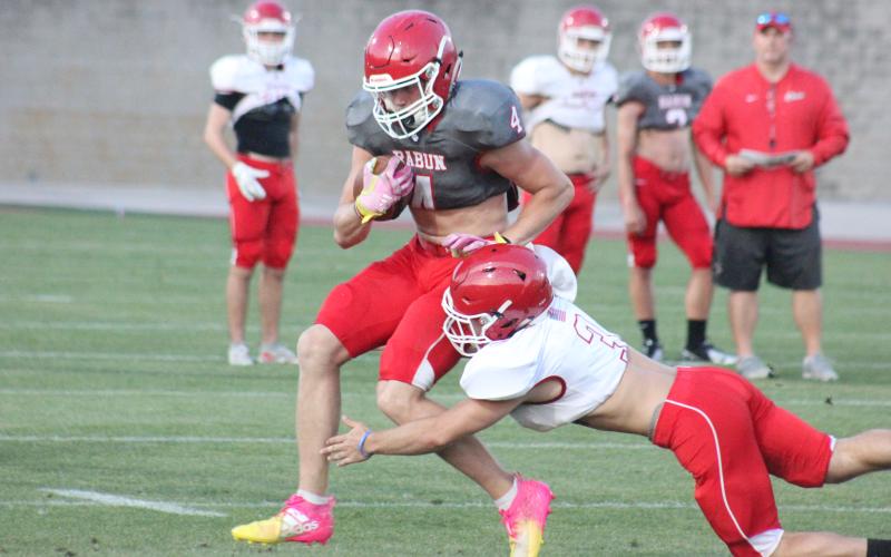 Rabun County linebacker AJ Wheeler (3) tackles wide receiver Braxton Hicks during the team’s spring scrimmage at Frank Snyder Memorial Stadium in Tiger on May 17. (Glendon Poe/The Clayton Tribune)
