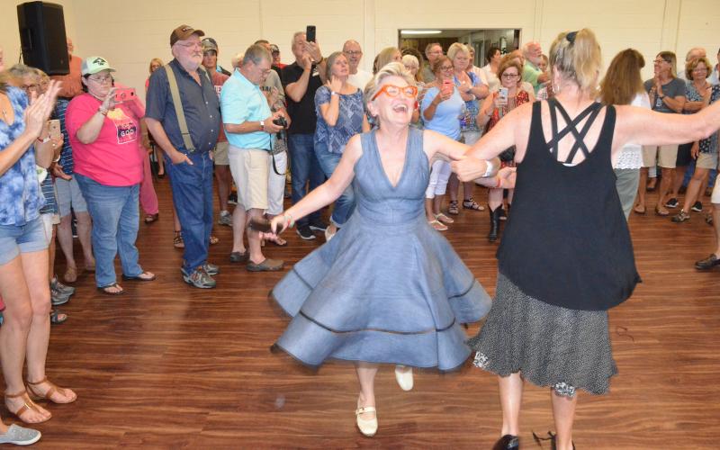 Wayne Knuckles/The Clayton Tribune. Cyndae Arrendale of Clarkesville twirls across the dance floor Saturday in Mountain City. The event was part of Rabun County's 200th birthday celebration.