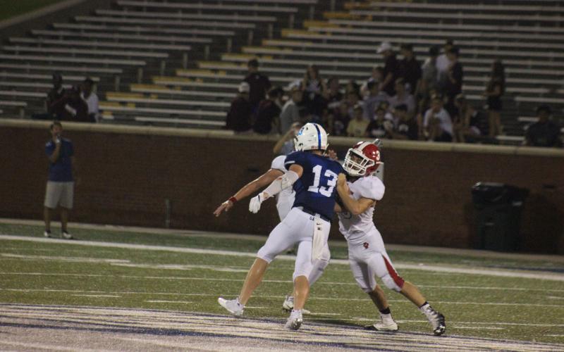 Rabun County’s AJ Wheeler, right, blocks a Bremen defensive player during a punting situation in the Erk Russell Classic at Georgia  Southern’s Paulson Stadium in Statesboro last August. (File Photo).