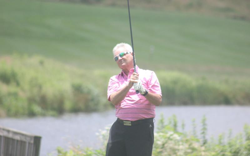Jay Anderson watches his shot during the Sid Weber Memorial Cancer Fund golf tournament at Sky Valley Country Club last Wednesday. (Photo by Glendon Poe/The Clayton Tribune)