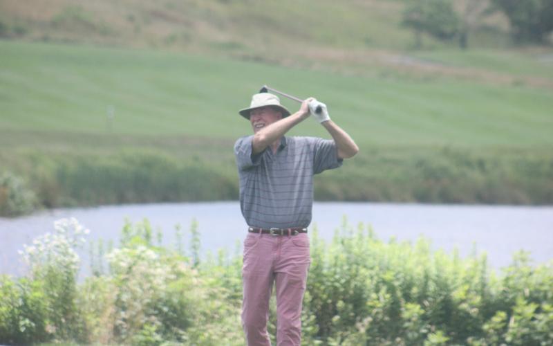Larry Kirkman watches his shot on No. 18 during the Sid Weber Memorial Cancer Fund golf tournament at Sky Valley Country Club last Wednesday. (Photo by Glendon Poe/The Clayton Tribune)
