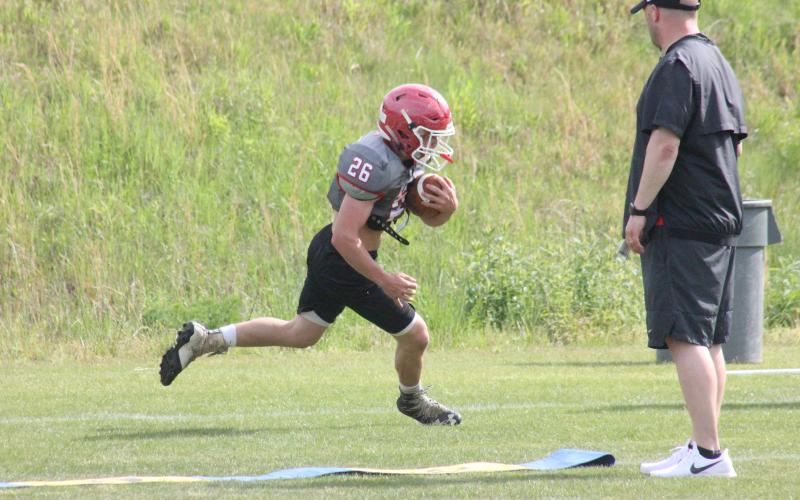 Rabun County running back Bryson Addis carries the ball during a position workout at the team’s practice field in May. (Glendon Poe/The Clayton Tribune)
