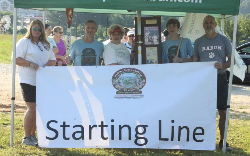 From left, Stephanie Quilliams, Anthony Lampros, Joye Spates, Guy Gober and Roy Quilliams are pictured at the Bicentennial Torch and Flag Run in Clayton on Saturday morning. (Glendon Poe/The Clayton Tribune)