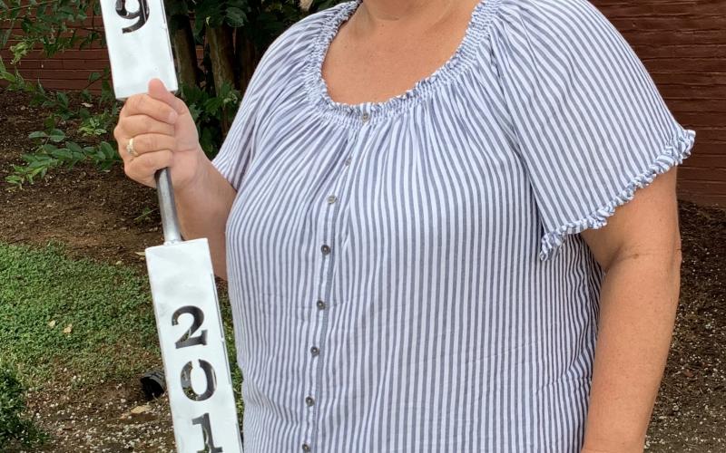 Teka Earnhardt holds the ceremonial torch that will be carried through the streets of Clayton Saturday as part of Rabun County's 200th birthday celebration.
