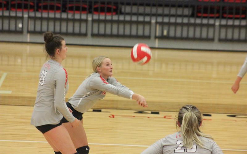 Rabun County’s Ali Ramey, right, digs at the ball, while teammate Destiny Deetz awaits the bounce during a match against Lumpkin County at Ken Byrd Court in Tiger on Tuesday night. (Glendon Poe/The Clayton Tribune)