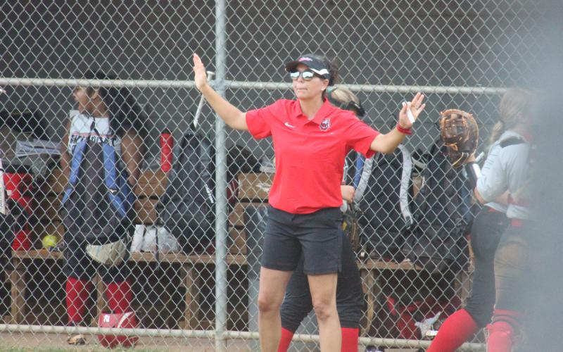 Rabun County coach Angela Shepheard congratulates her team for closing an inning without surrendering runs during a game against Dawson at Rabun County High School in Tiger last Thursday. (Glendon Poe/The Clayton Tribune)