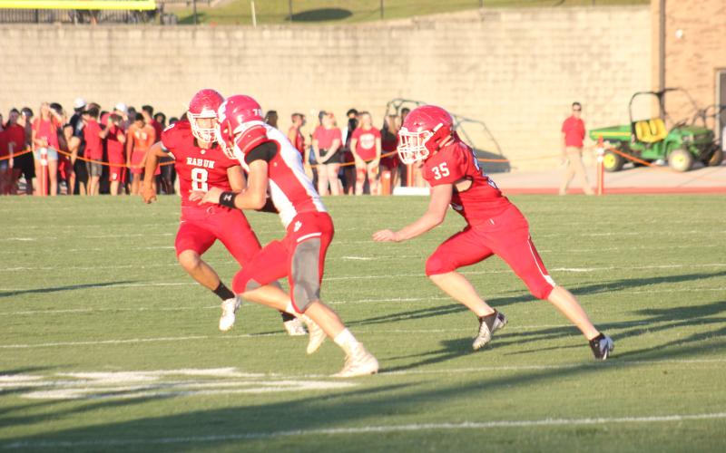 Rabun County safety Garrett Bragg (8) and teammate Trent Miller (35) pursue a Franklin (N.C.) ballcarrier during a preseason game at Frank Snyder Memorial Stadium in Tiger last Friday night. (Glendon Poe/The Clayton Tribune)