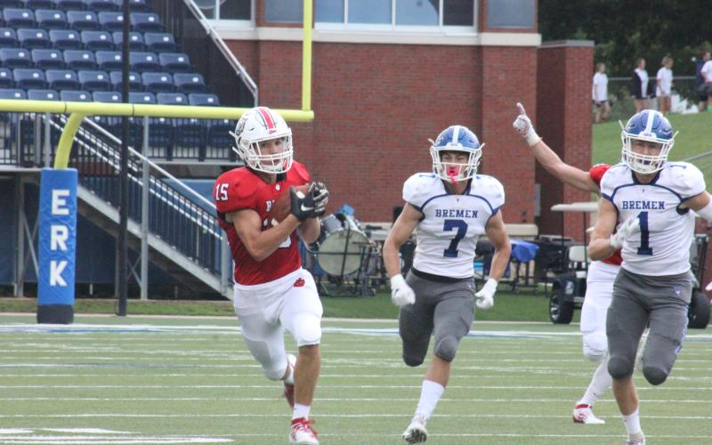 Rabun County wide receiver Sam Adams (15) makes a catch against Bremen during the first half in the Erk Russell Classic at Georgia Southern’s Paulson Stadium in Statesboro last Saturday night. (Glendon Poe/The Clayton Tribune)