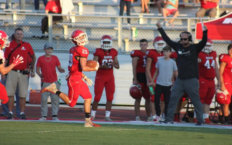 Rabun County wide receiver Sutton Jones (20) runs along the sideline en route to a touchdown during a preseason game against Franklin (N.C.) at Frank Snyder Memorial Stadium in Tiger last Friday night. (Glendon Poe/The Clayton Tribune)