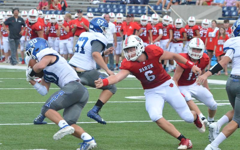 Rabun County defensive lineman Will McCraw (6) pursues Bremen running back Hank Steed (30) during the first half in the Erk Russell Classic at Georgia Southern’s Paulson Stadium in Statesboro last  Saturday night. (Wayne Knuckles/The Clayton Tribune)