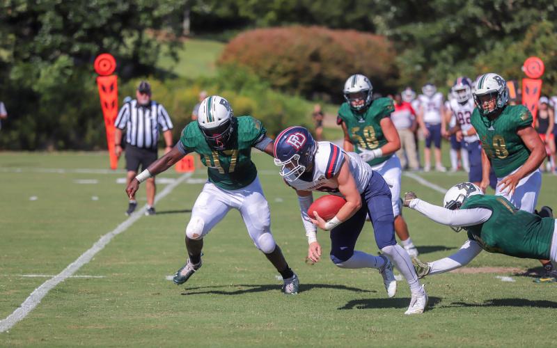 Rabun Gap-Nacoochee linebacker Kyle Ormsby (47), and teammates Gavin Anderson (58) and Deston Worthy (8) pursue a Providence Day (N.C.) ballcarrier during a game in Rabun Gap on Aug. 30. (Rabun Gap-Nacoochee School)
