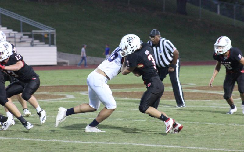 Rabun County linebacker AJ Wheeler (3) is blocked by a Putnam County wide receiver while rushing the line of scrimmage during the first half at Frank Snyder Memorial Stadium in Tiger last Friday night. (Glendon Poe/The Clayton Tribune)