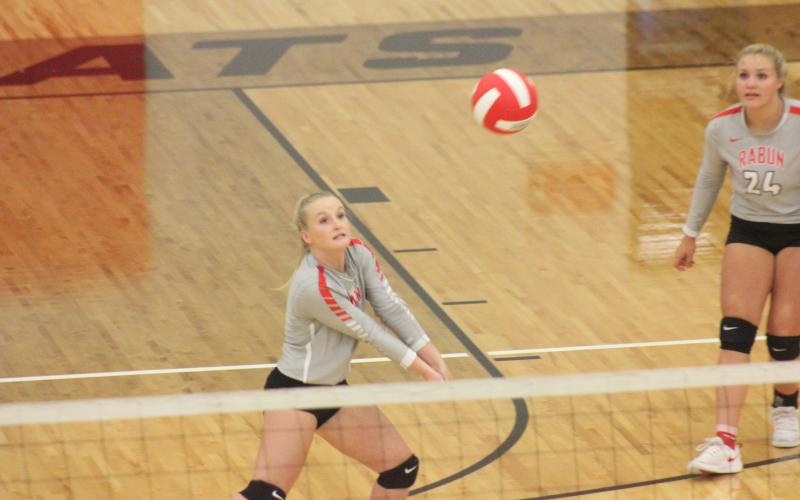 Rabun County’s Ali Ramey, left, digs at a ball, while teammate Beth Payne looks on during a match against Cherokee Bluff at Rabun County’s Ken Byrd Court in Tiger last Thursday. (Glendon Poe/The Clayton Tribune)
