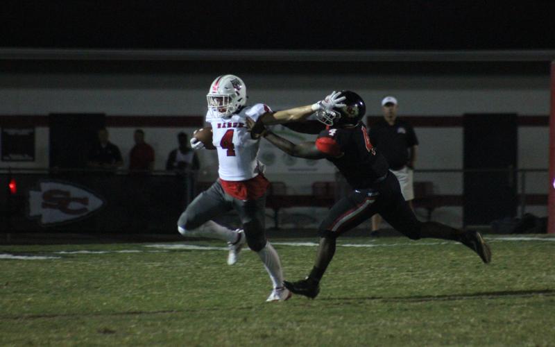 Rabun County wide receiver Braxton Hicks, left, stiff-arms Stephens County tight end Kenny Davis during the first half in Toccoa last Friday night. (Glendon Poe/The Clayton Tribune)