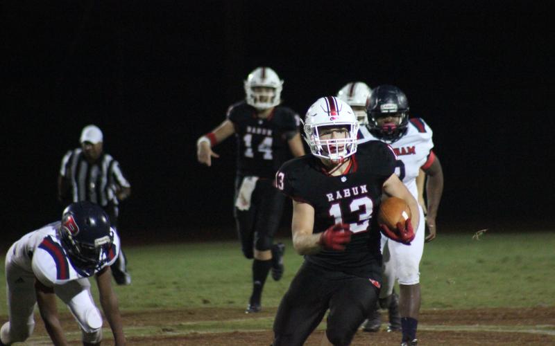 Rabun County running back Brody Jarrard (13) carries the ball behind blockers during the first half against Putnam County at Frank Snyder Memorial Stadium in Tiger last Friday night. (Glendon Poe/The Clayton Tribune)