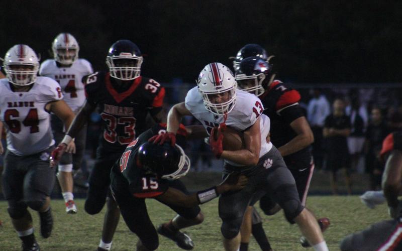 Rabun County running back Brody Jarrard (13) avoids a tackle from Stephens County safety Javian Hightower (15) during the first half in Toccoa last Friday night. (Glendon Poe/The Clayton Tribune)