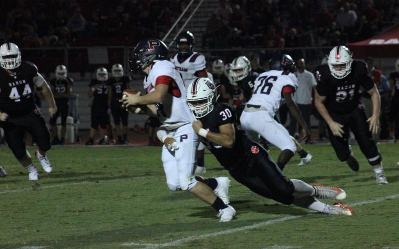 Rabun County linebacker Hoffman Windham (30) tackles a Putnam County ballcarrier during the first half at Frank Snyder Memorial Stadium in Tiger last Friday night. (Glendon Poe/The Clayton Tribune)