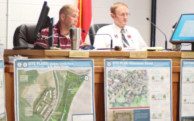 Megan Broome/The Clayton Tribune. Mayor Green, left, and city attorney Mitch Baker listen as Heather Feldman, representative from Georgia Mountains Regional Commission (GMRC), talks to city council members about GMRC’s plan to update the city of Clayton’s Charter and the Clayton city council meeting Tuesday.