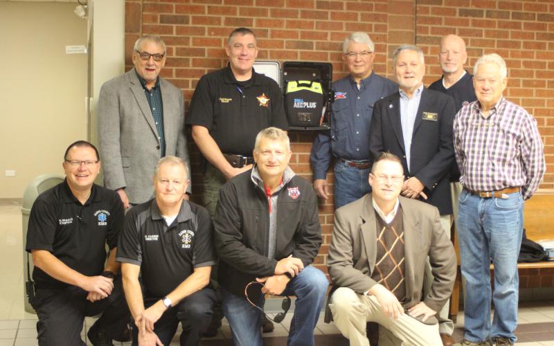 Megan Broome/The Clayton Tribune. The Rotary Club of Clayton has donated four Automated External Defibrillators to Rabun County EMS, two of which replaced old AED’s at the courthouse. Front, from left, Trampes Stancil, EMS captain, Mike Carnes, EMS director, Darrin Giles, county administrator, Tony Penrose; Middle, from left, Tim Ranney, Rotary president, Ray Pagano; Back, from left, Wayne Knuckles, Sheriff Chad Nichols, David Tatum and Matt Mitcham.