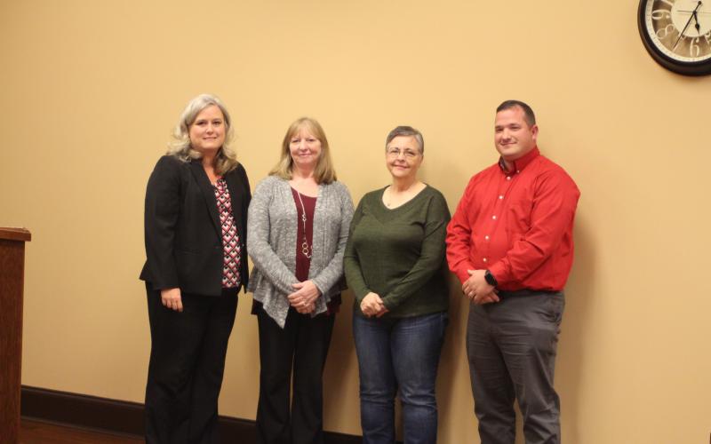 Megan Broome/The Clayton Tribune. Superintendent April Childers, left, Marsha Smith, Donna Headrick, bus driver, and Marty Dixon, transportation director recognize Smith for her 33 years of dedication to Rabun County Schools at the Board of Education meeting on Thursday, Oct. 17.