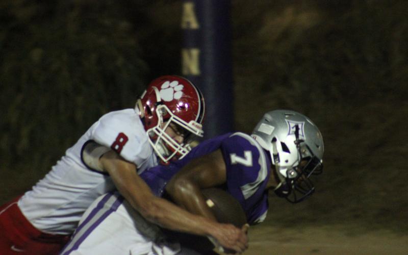 Rabun County safety Garrett Bragg (8) tackles Monticello quarterback Keyshawn Ammons during the second half in Monticello last Friday night. (Glendon Poe/The Clayton Tribune)