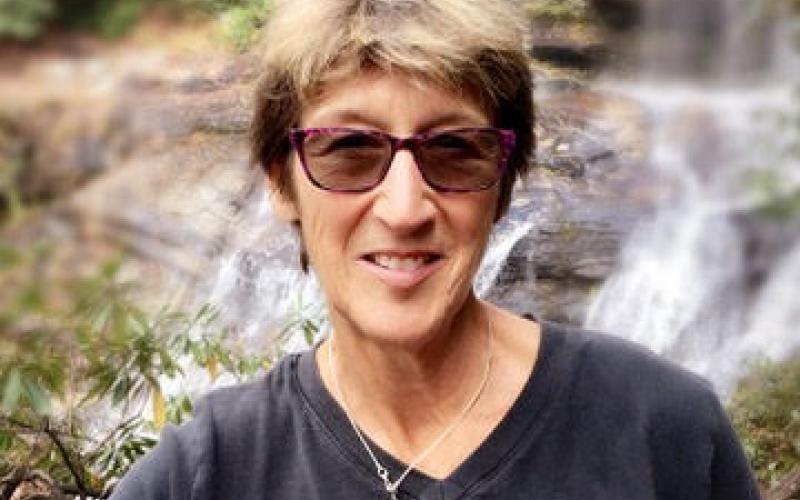 Megan Broome/The Clayton Tribune. Marie Dunkle, board president for Georgia ForestWatch, sits at a local waterfall. Georgia ForestWatch is a watchdog organization that works to make sure that any projects the Forest Service does are healthy for the National Forest and Watersheds.